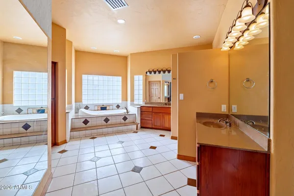 a spacious bathroom with a mirror a bathtub and a shower
