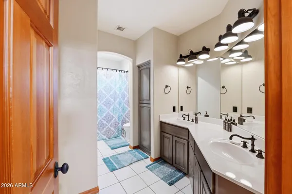 a bedroom with furniture and a large window