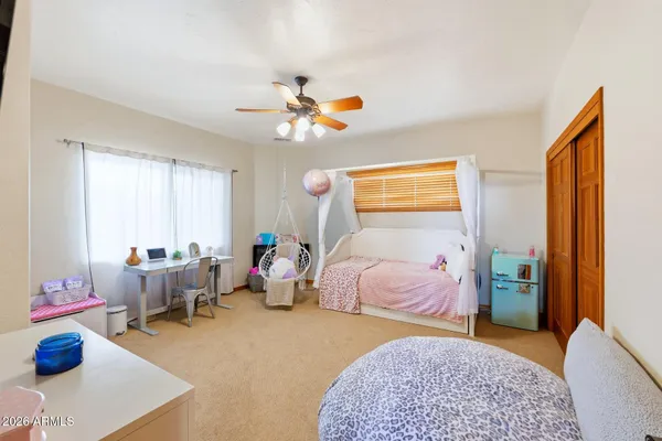 a bedroom with furniture and a floor to ceiling window