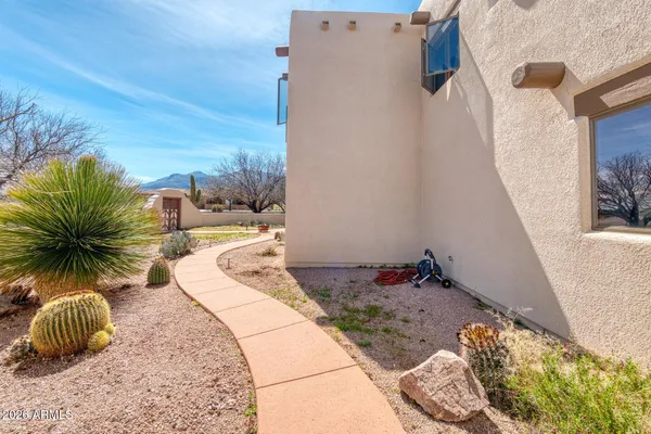 a view of a house with a yard covered in snow