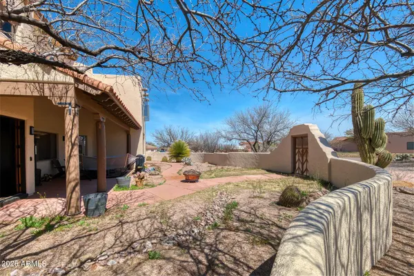 a view of backyard with a table and chairs under an umbrella