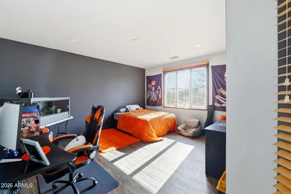 a bed room with a bed and a chair