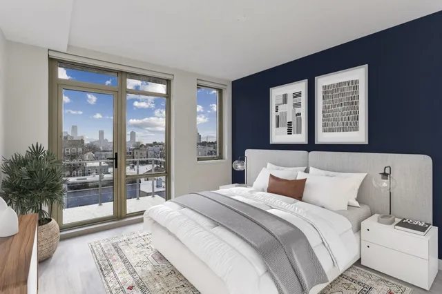 a bedroom with a large bed and a large window