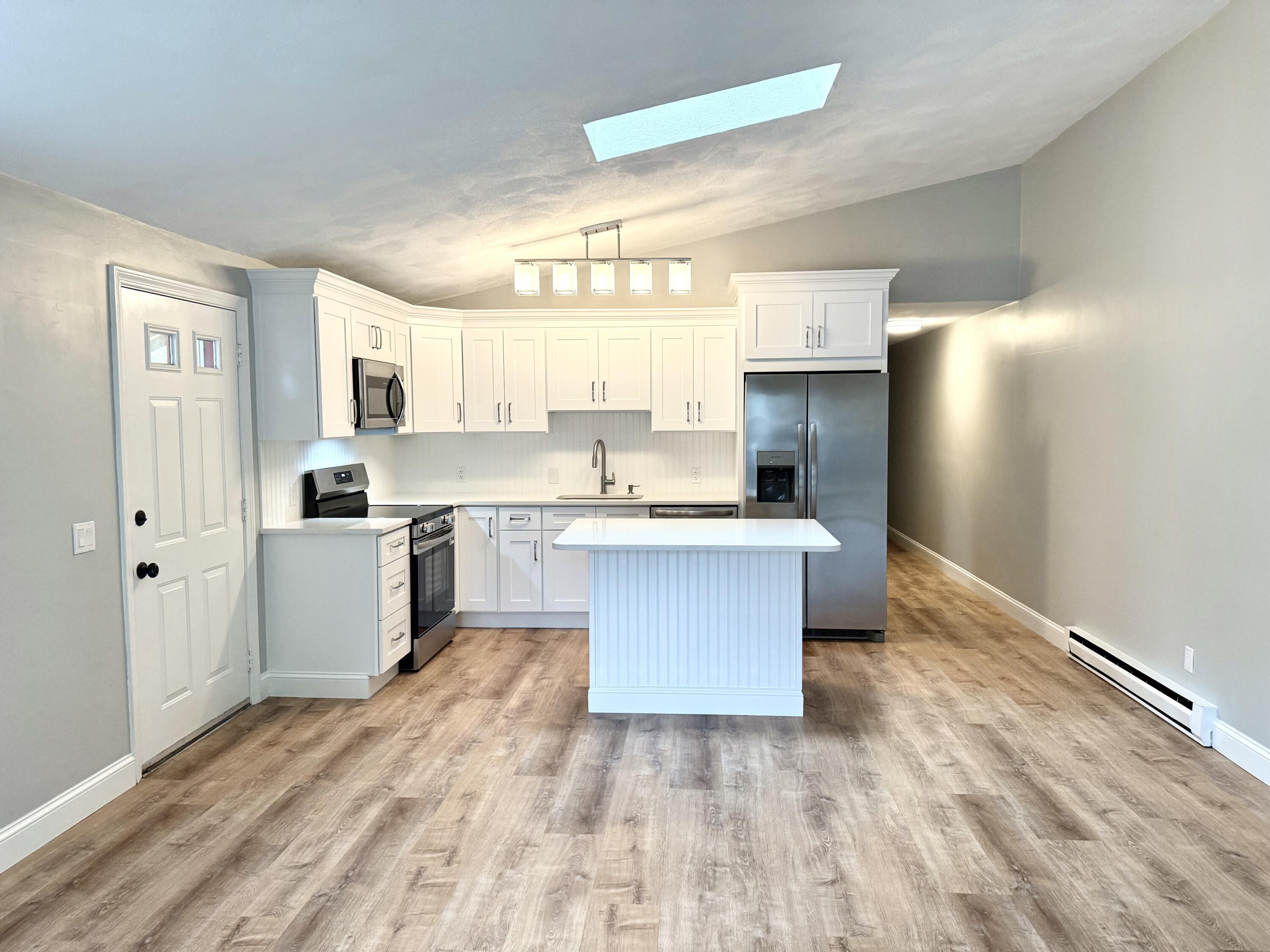 70 Cape Drive, Unit 4C Mashpee, MA 02649 - Photo 1 of 6 a large kitchen with a white stove top oven and white cabinets