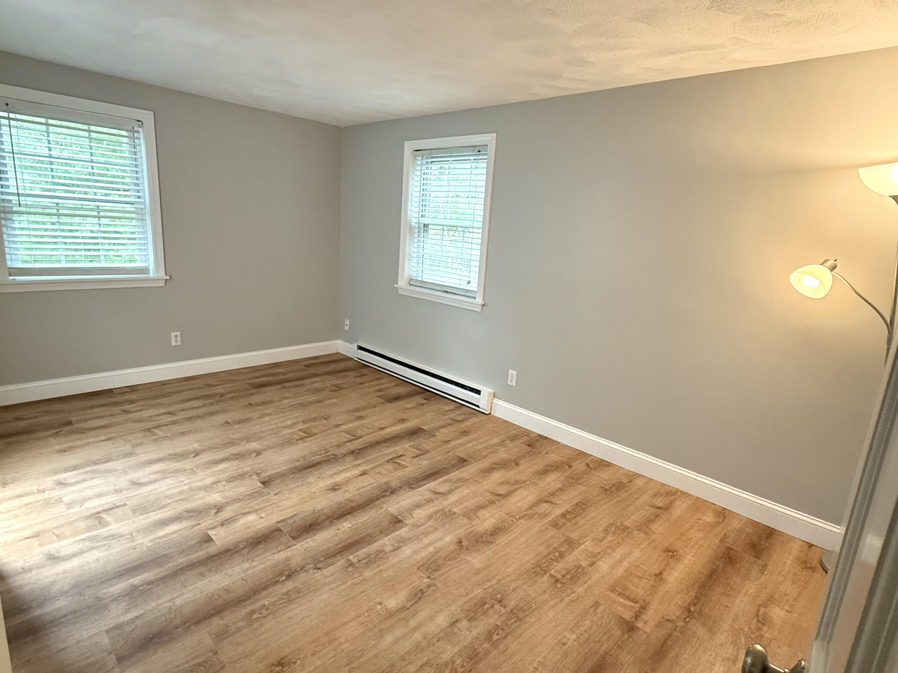 70 Cape Drive, Unit 4C Mashpee, MA 02649 - Photo 6 of 6 a view of empty room with wooden floor and fan