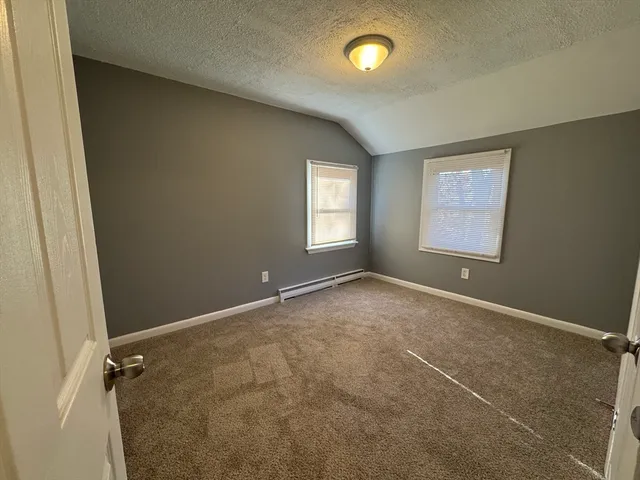 an empty room with windows and closet