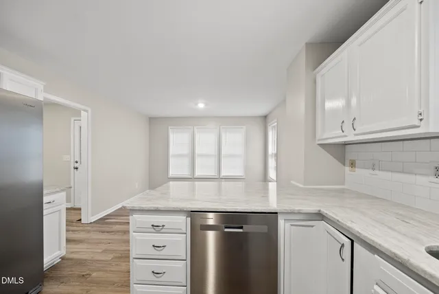 a kitchen with stainless steel appliances granite countertop a sink and a stove