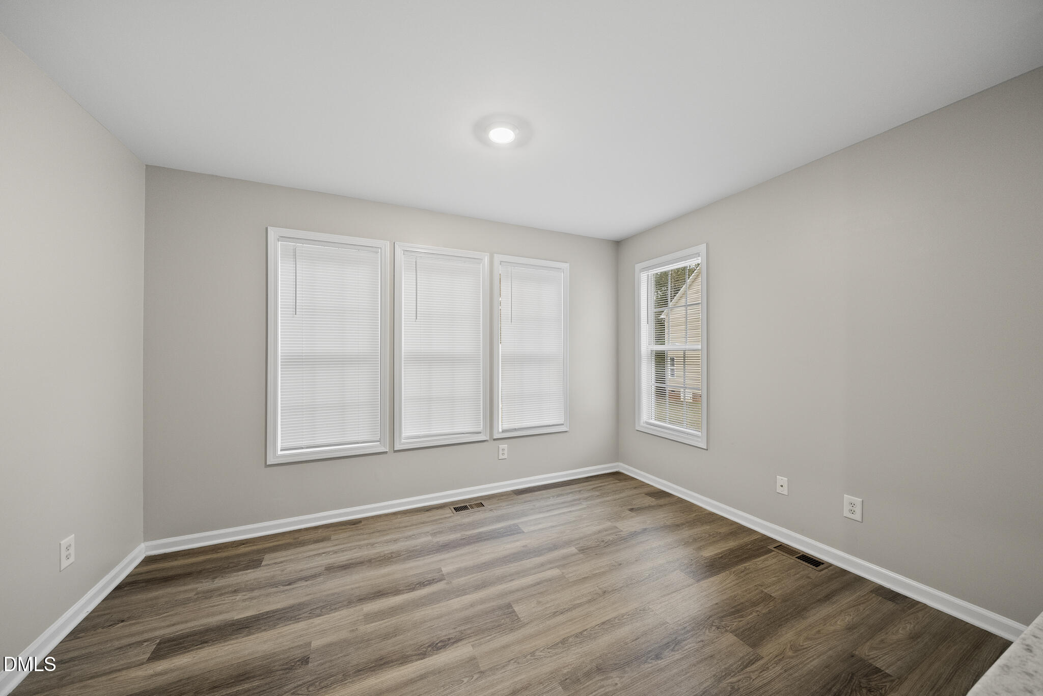 201 Tonylee Court, Unit B Raleigh, NC 27603 - Photo 13 of 29 wooden floor in an empty room with a window