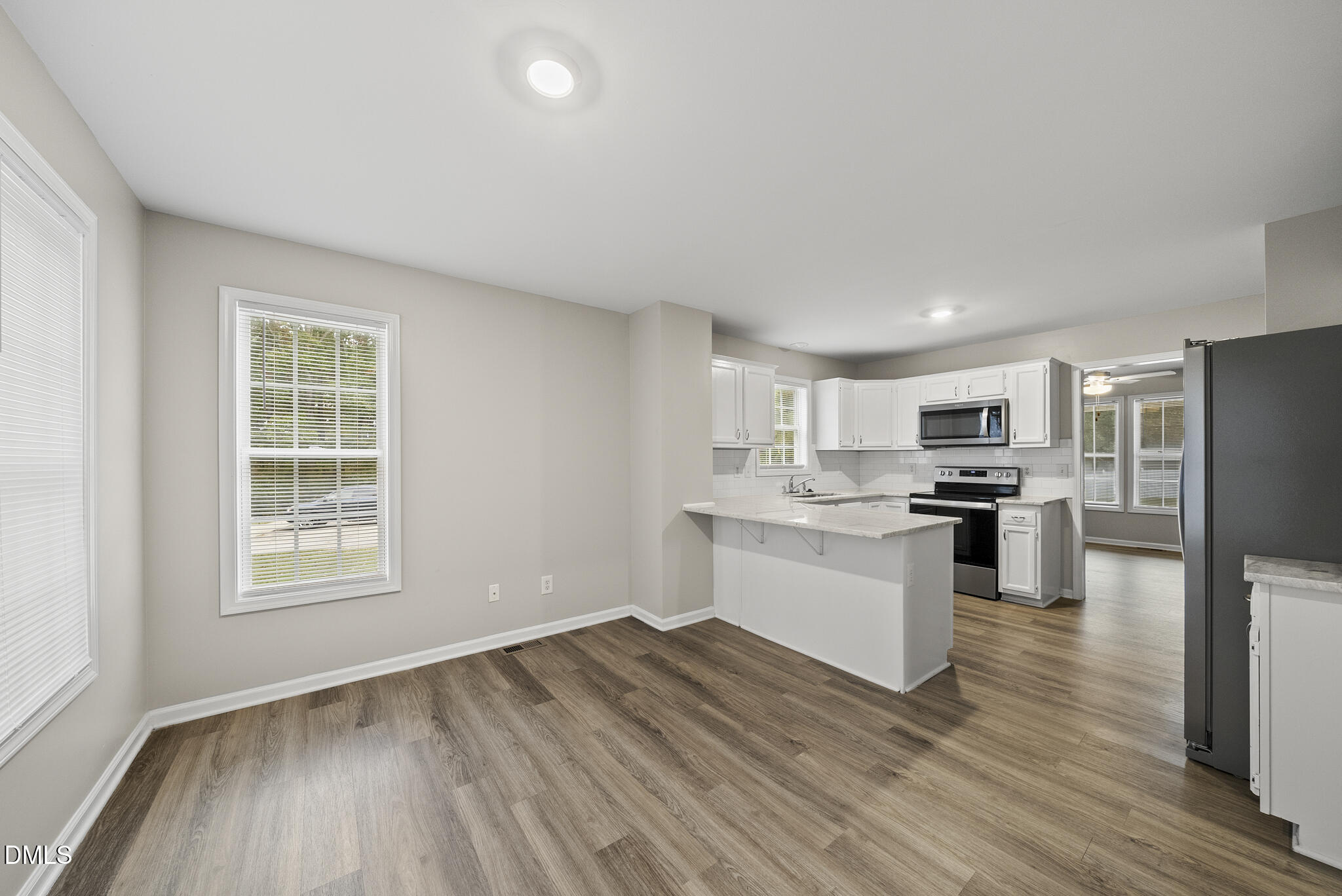 201 Tonylee Court, Unit B Raleigh, NC 27603 - Photo 14 of 29 a kitchen with a refrigerator and a stove top oven