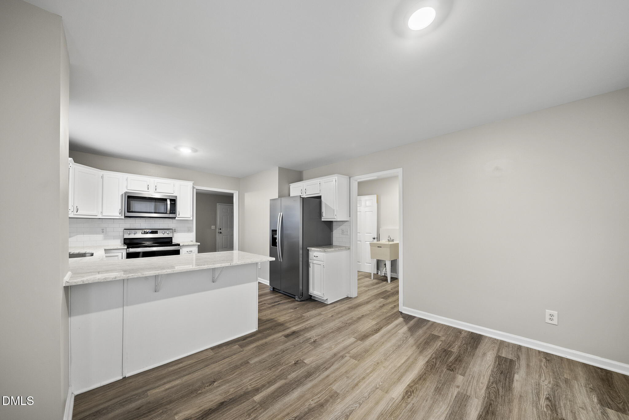 201 Tonylee Court, Unit B Raleigh, NC 27603 - Photo 15 of 29 a kitchen with a refrigerator and a stove top oven