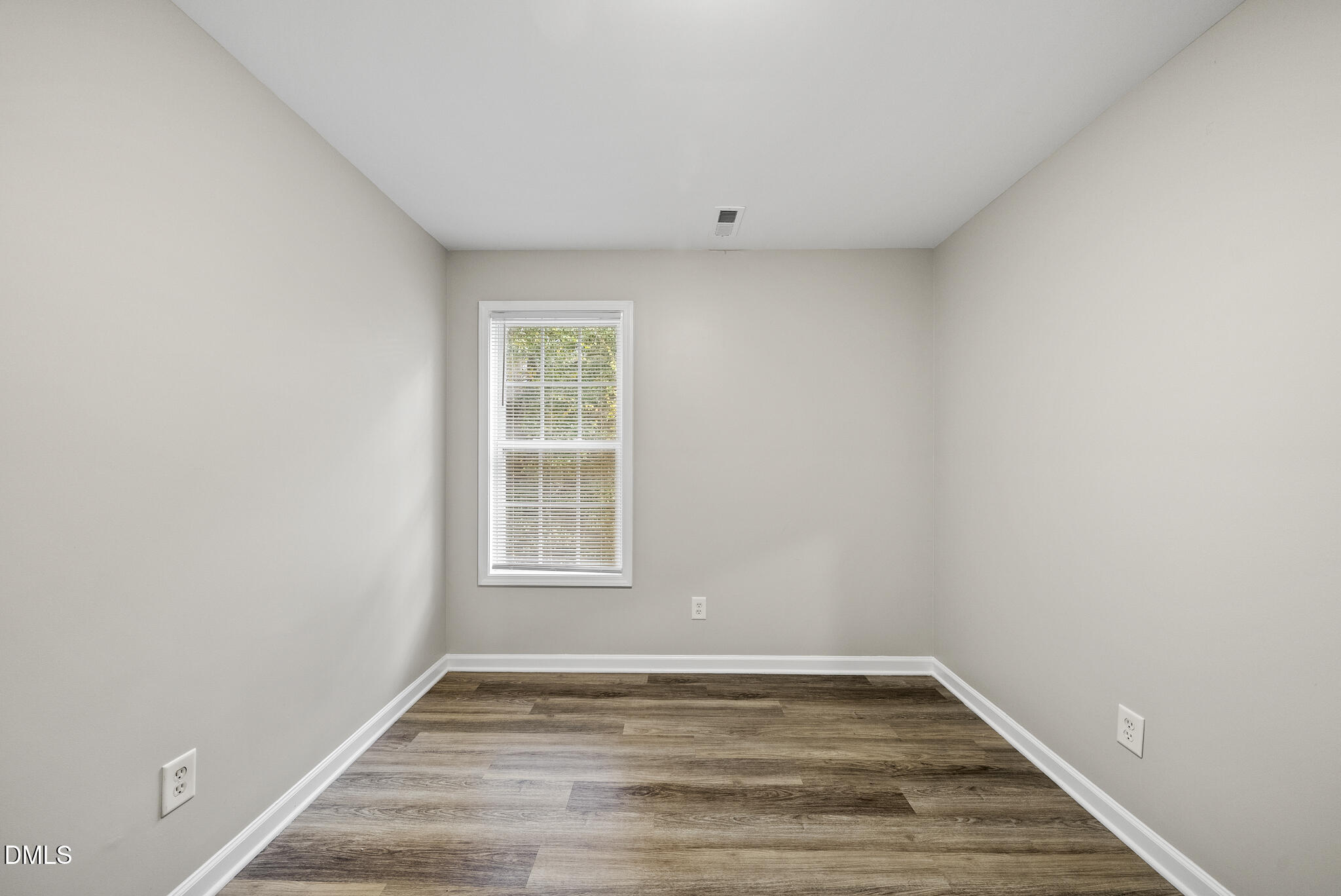 201 Tonylee Court, Unit B Raleigh, NC 27603 - Photo 22 of 29 a view of an empty room with wooden floor and a window