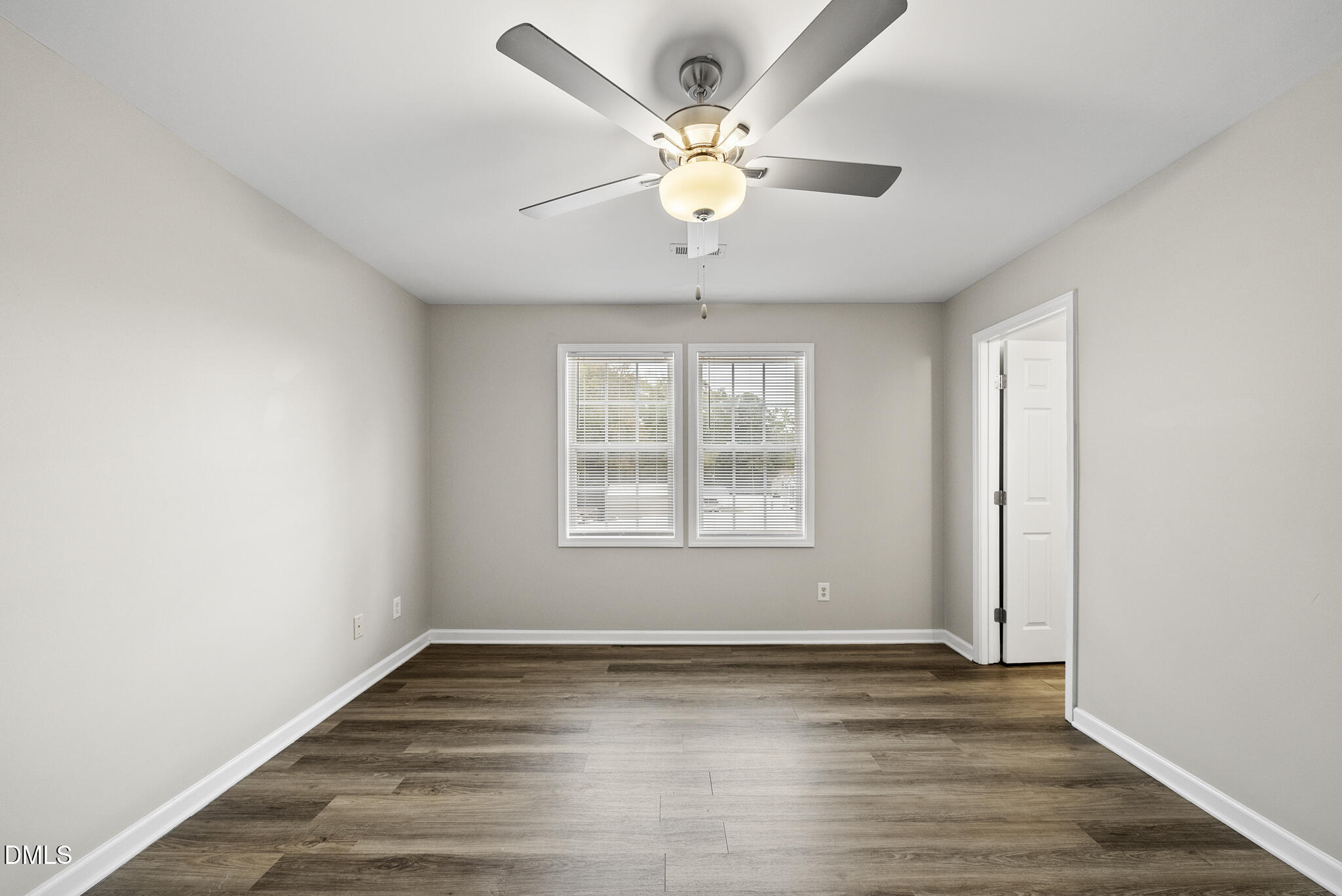 201 Tonylee Court, Unit B Raleigh, NC 27603 - Photo 27 of 29 an empty room with wooden floor and windows