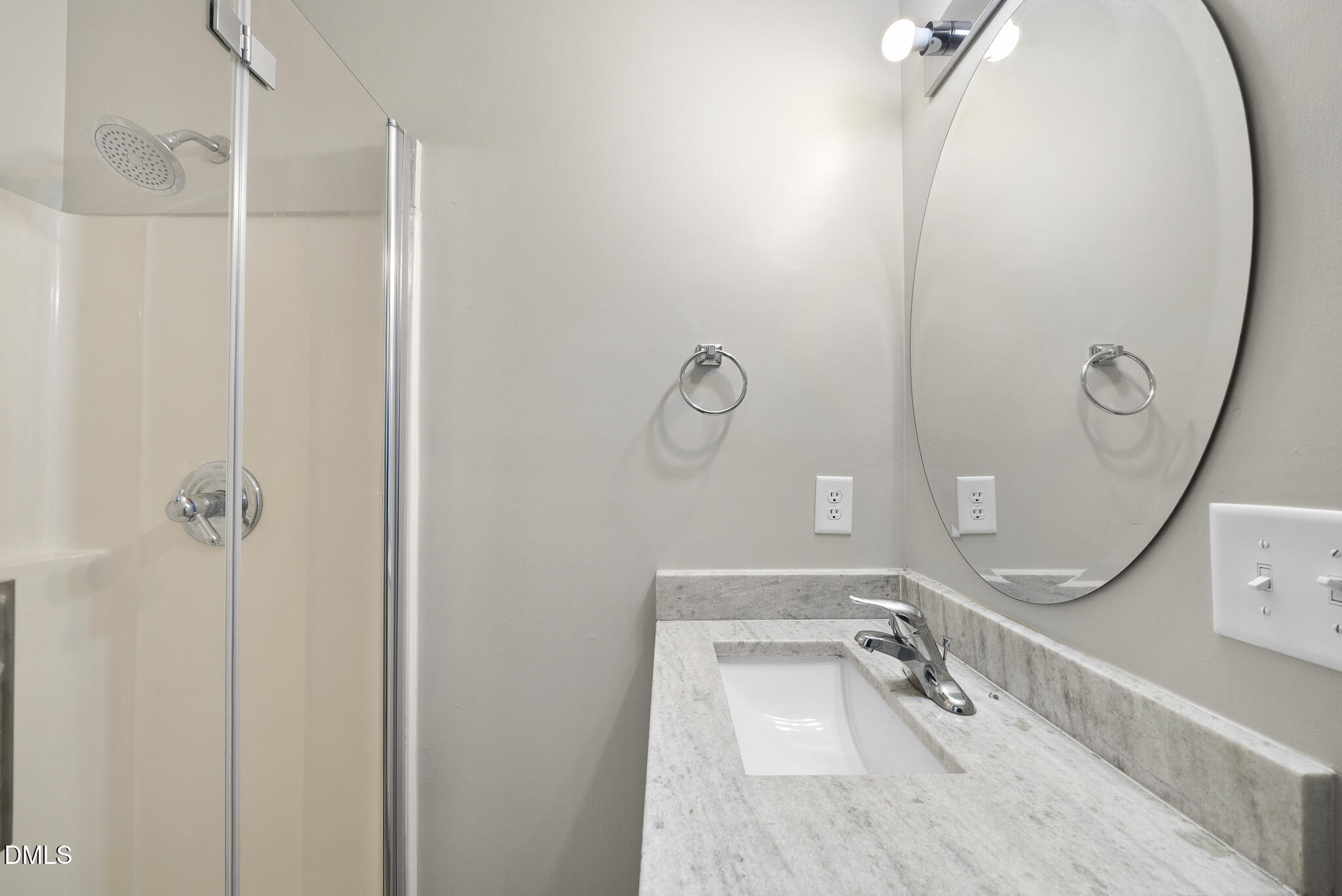 201 Tonylee Court, Unit B Raleigh, NC 27603 - Photo 28 of 29 a bathroom with a sink mirror and vanity