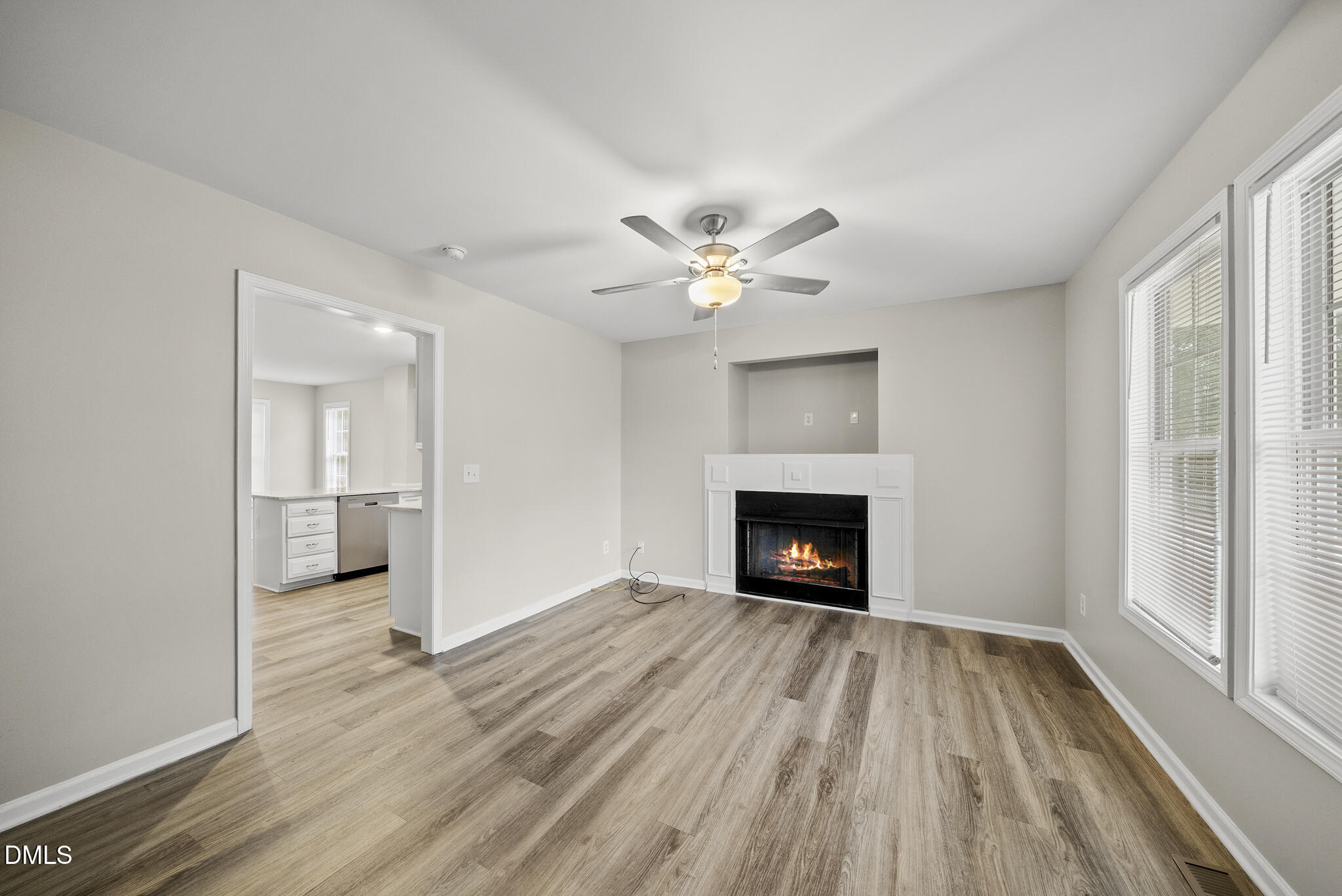 201 Tonylee Court, Unit B Raleigh, NC 27603 - Photo 5 of 29 wooden floor fireplace and windows in an empty room