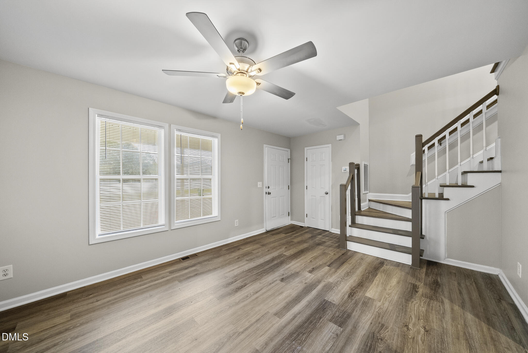 201 Tonylee Court, Unit B Raleigh, NC 27603 - Photo 8 of 29 a view of an empty room with wooden floor and a window