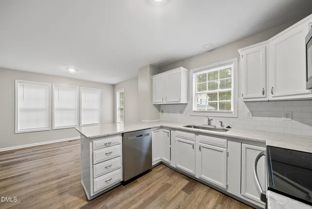 a kitchen with a sink stove and cabinets