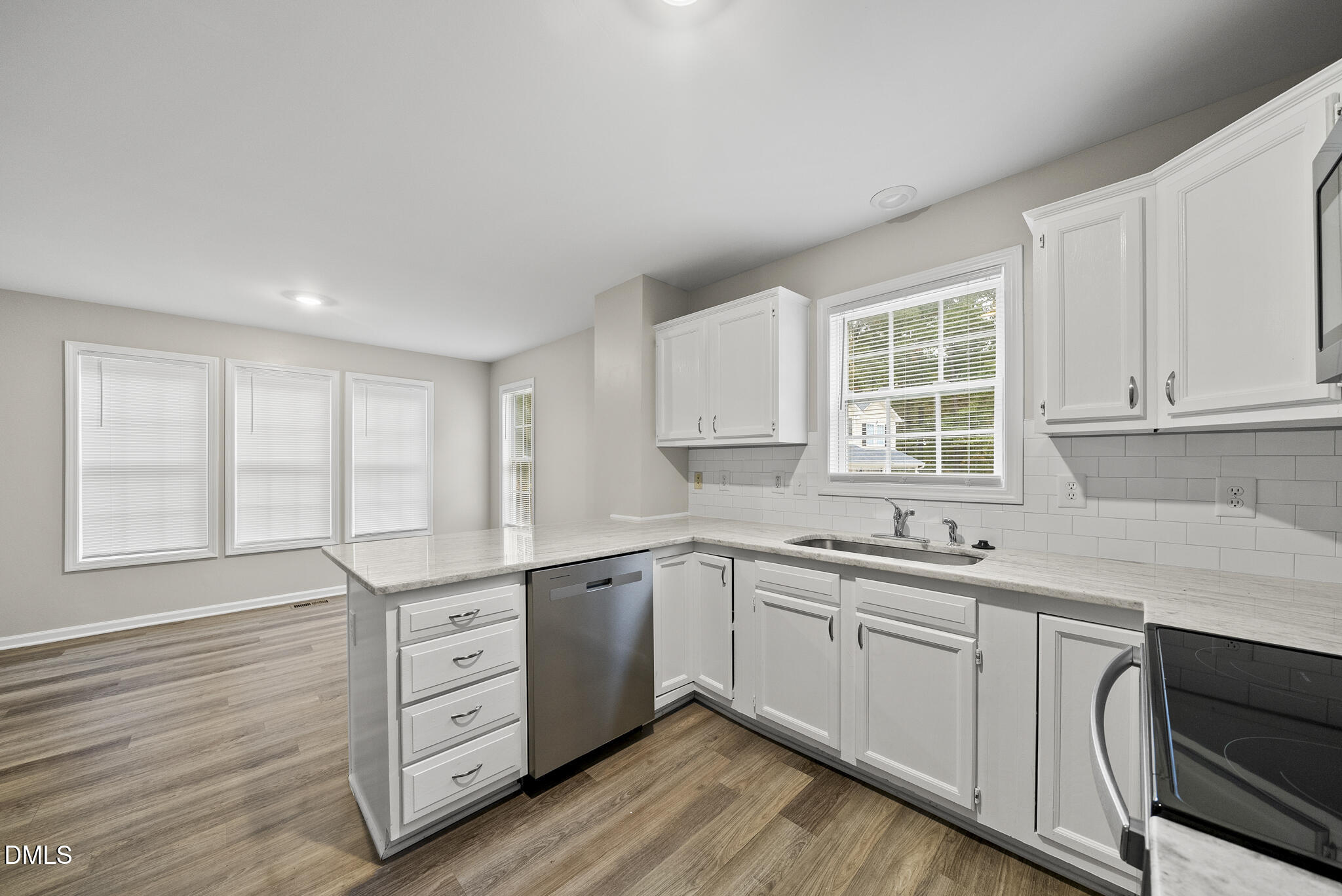 201 Tonylee Court, Unit B Raleigh, NC 27603 - Photo 9 of 29 a kitchen with a sink stove and cabinets