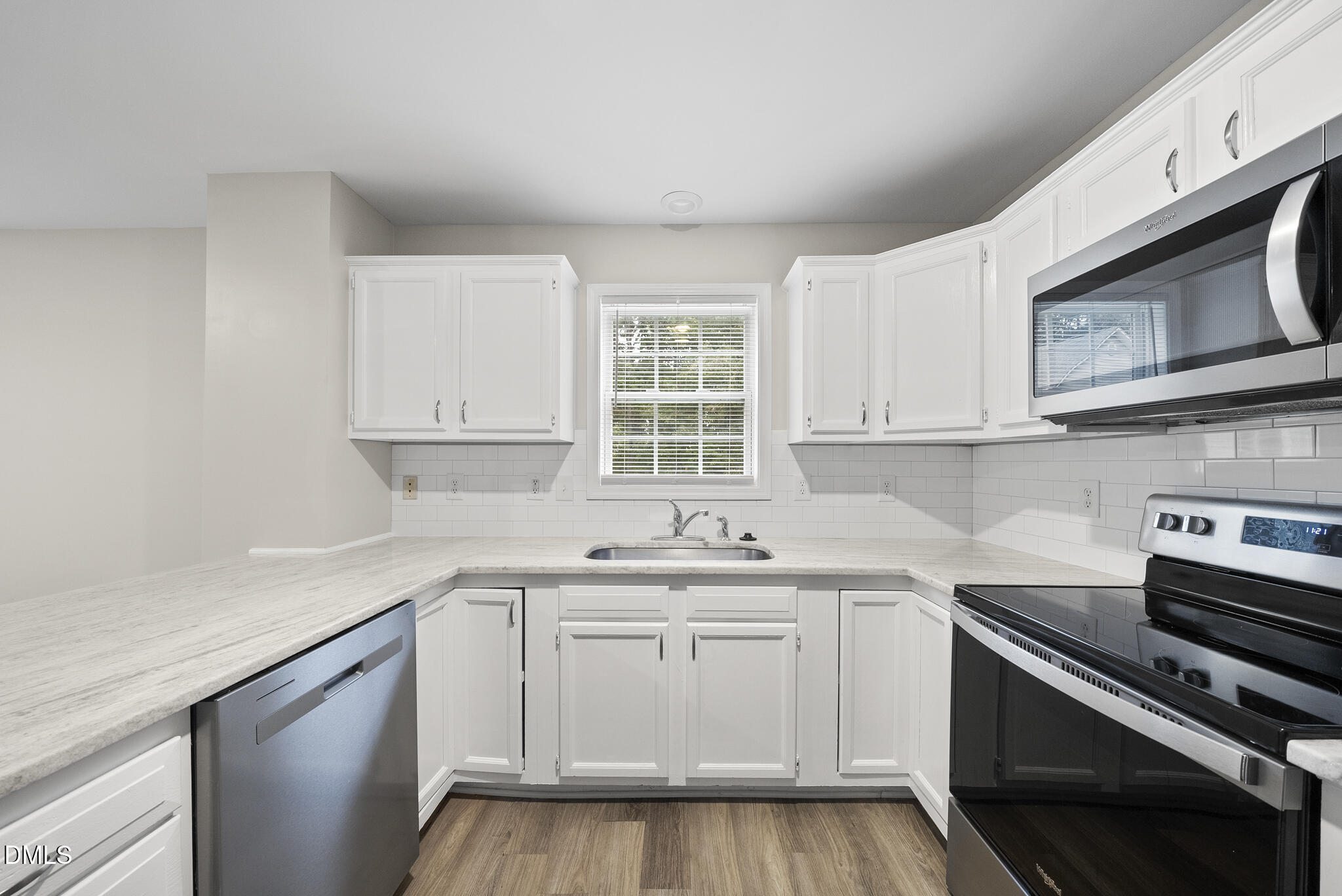 201 Tonylee Court, Unit B Raleigh, NC 27603 - Photo 10 of 29 a kitchen with stainless steel appliances white cabinets and a sink
