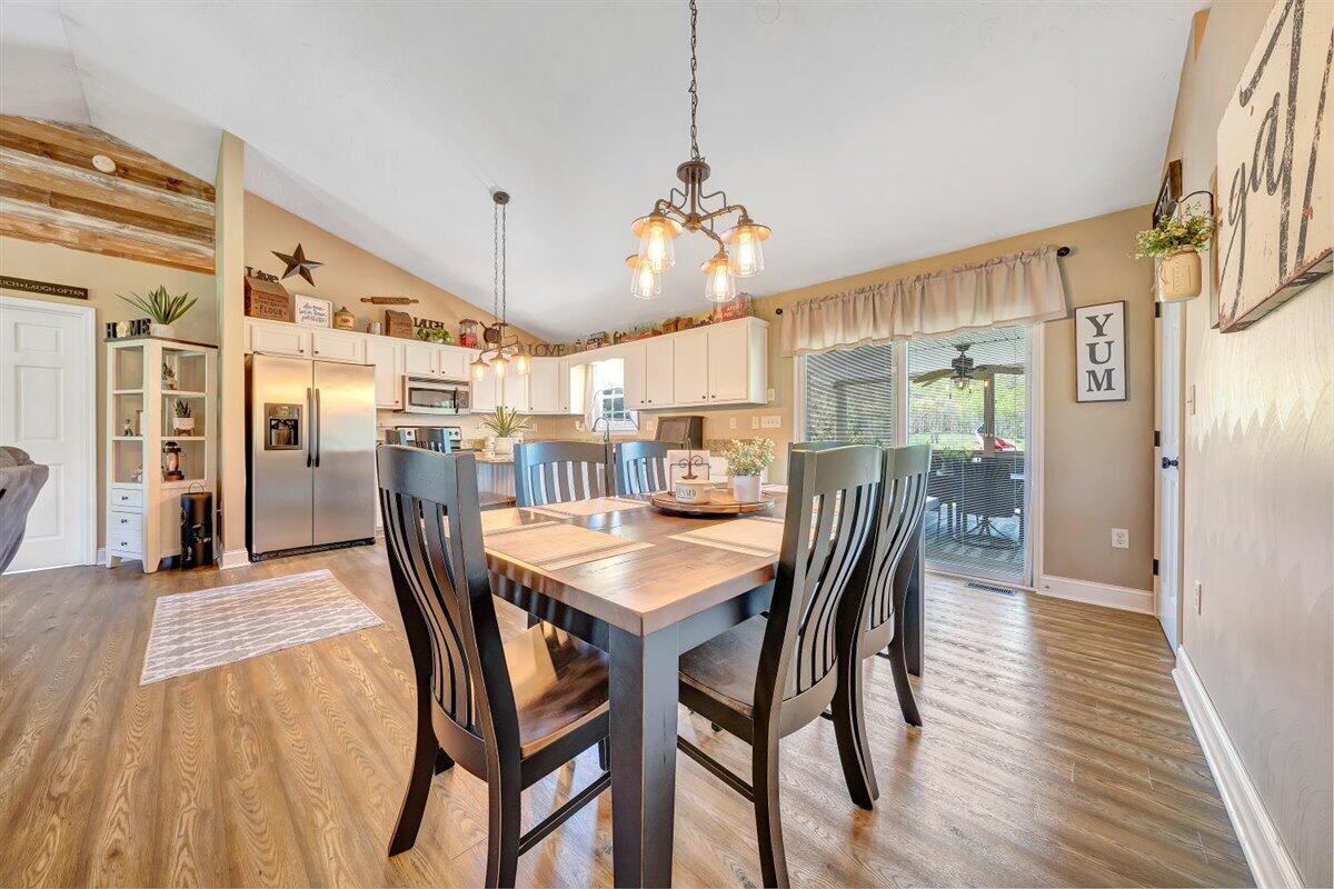 2947 Sandy Level Road Goodview, VA 24095 - Photo 11 of 73 a view of a dining room with furniture and wooden floor