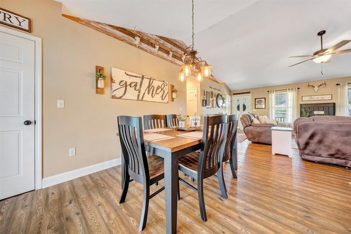 2947 Sandy Level Road Goodview, VA 24095 - Photo 13 of 73 a dining room with furniture a chandelier and wooden floor