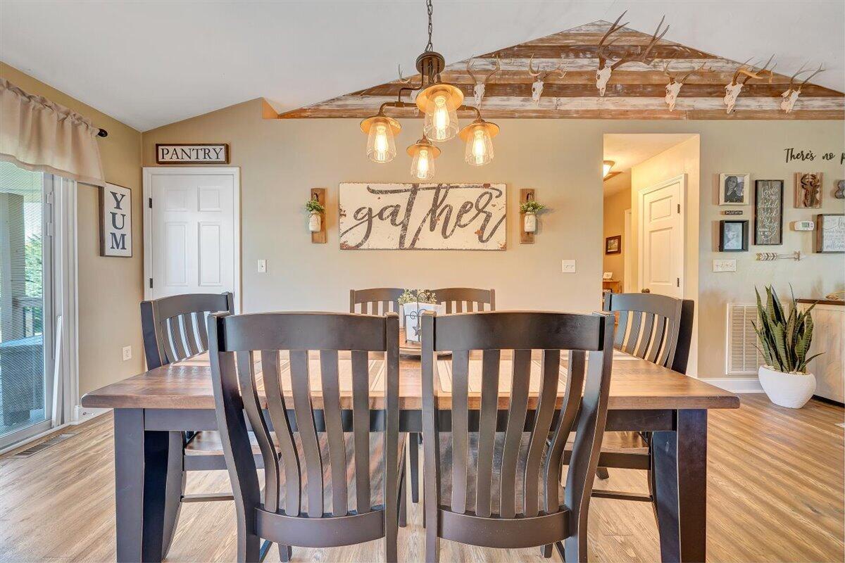 2947 Sandy Level Road Goodview, VA 24095 - Photo 15 of 73 a view of a dining room with furniture and wooden floor