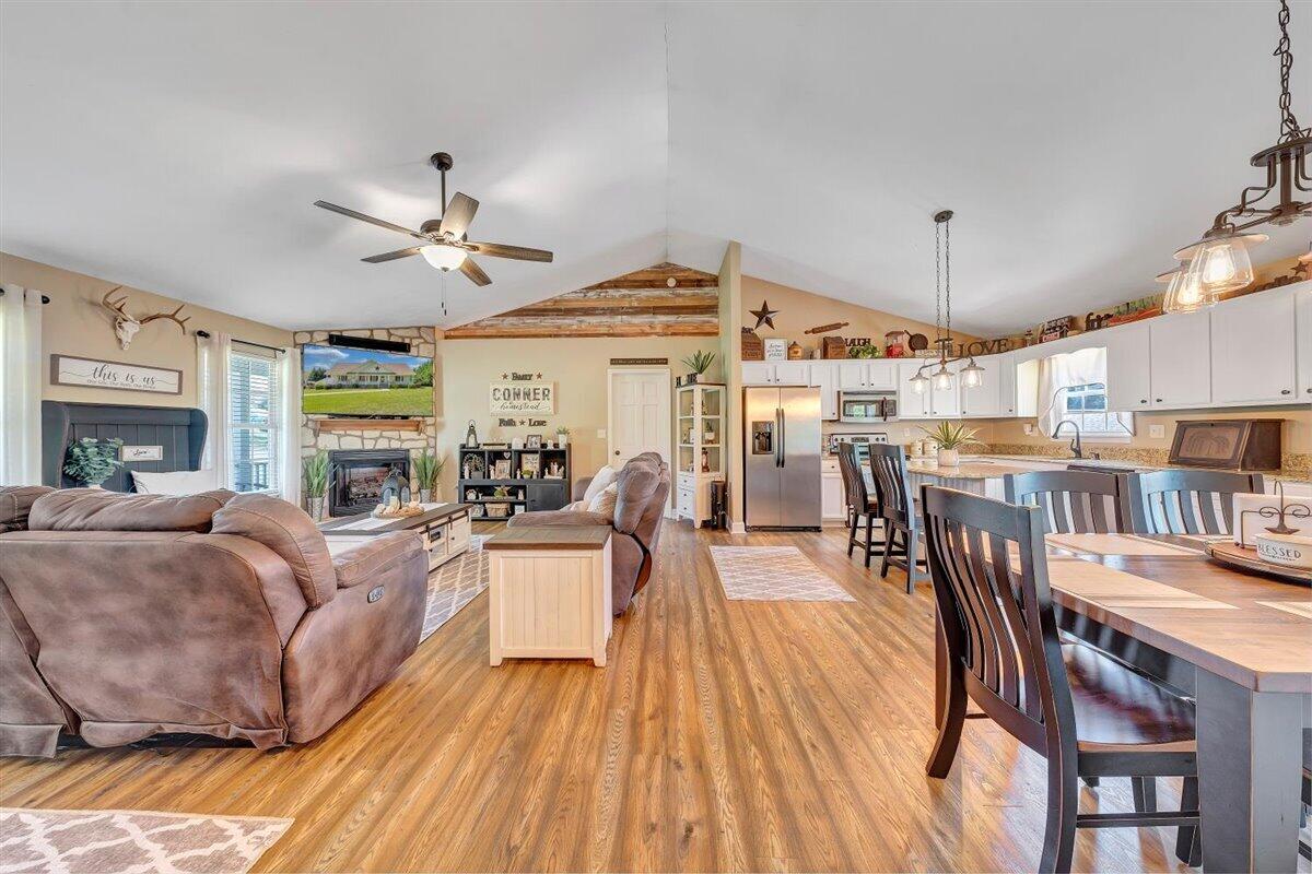 2947 Sandy Level Road Goodview, VA 24095 - Photo 20 of 73 a living room with furniture a fireplace and a chandelier