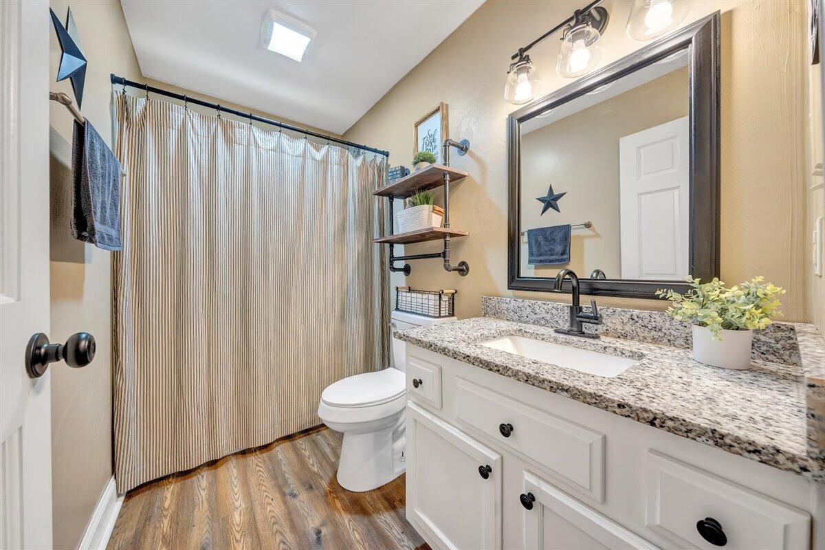 2947 Sandy Level Road Goodview, VA 24095 - Photo 31 of 73 a bathroom with a granite countertop sink and a mirror
