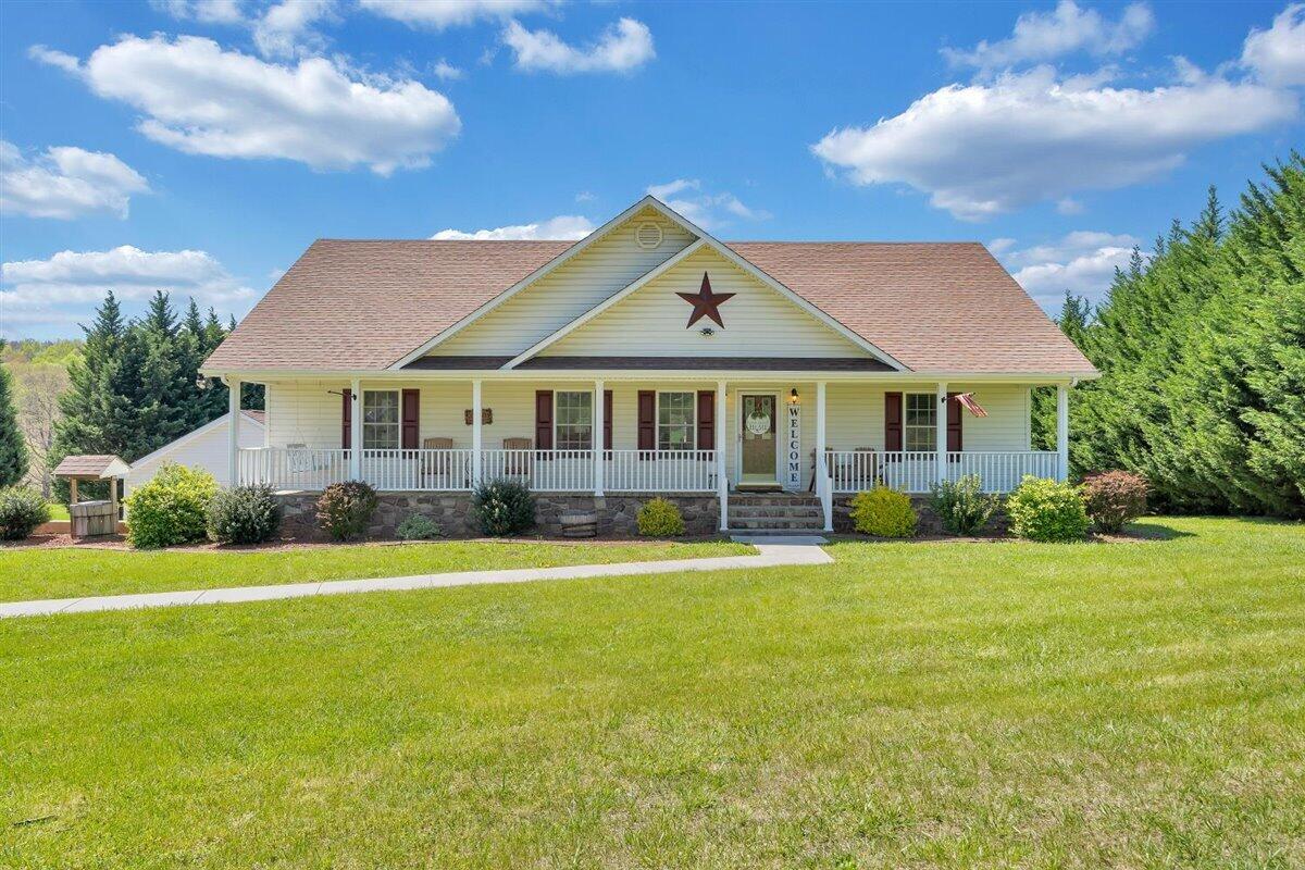 2947 Sandy Level Road Goodview, VA 24095 - Photo 6 of 73 a front view of a house with a garden and trees