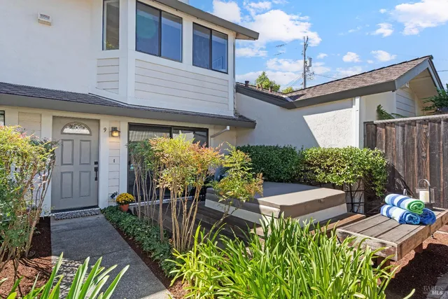 a front view of house with a garden