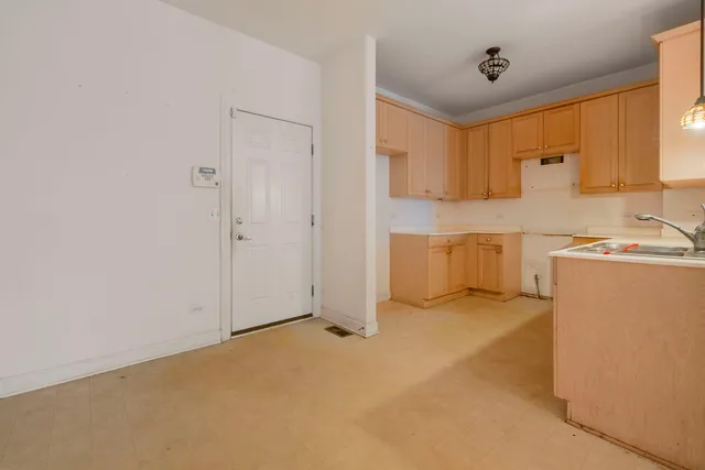 a view of a kitchen with a sink and a refrigerator