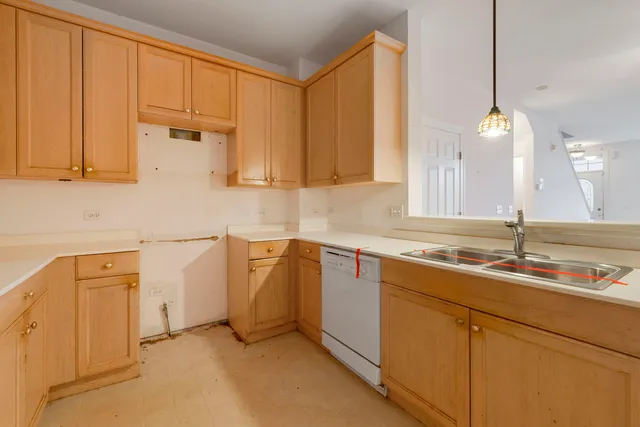 a kitchen with a sink cabinets and wooden floor