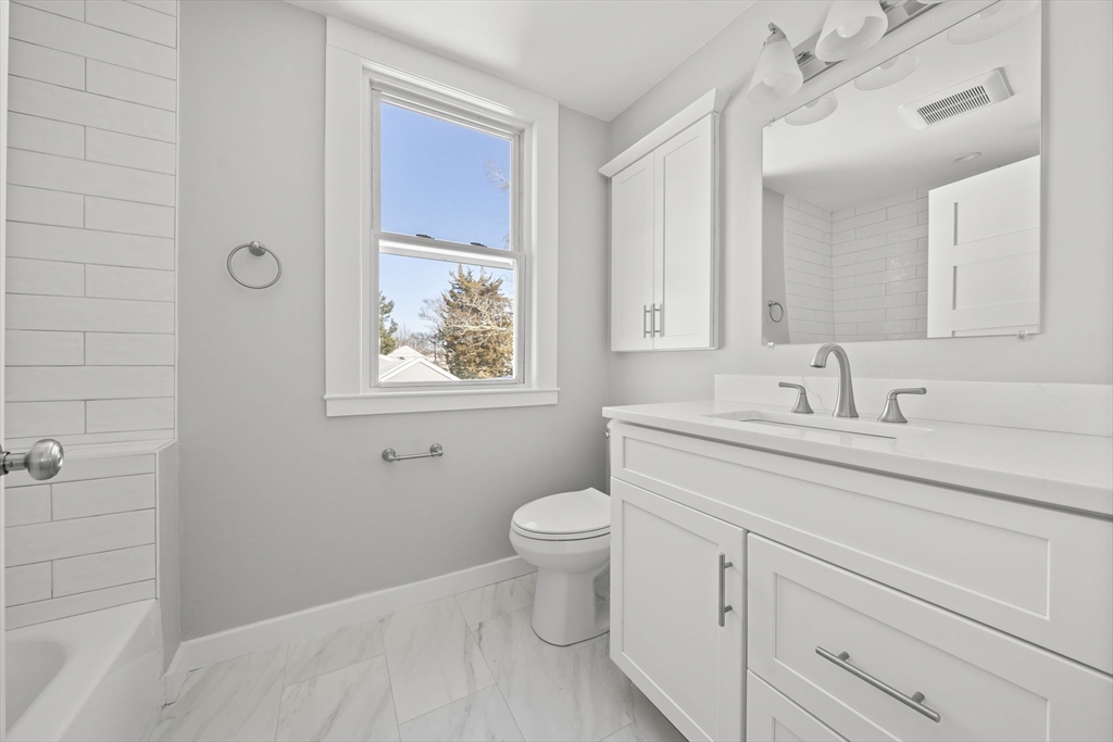 106 Darrow Street Quincy, MA 02169 - Photo 18 of 23 a bathroom with a toilet sink and mirror