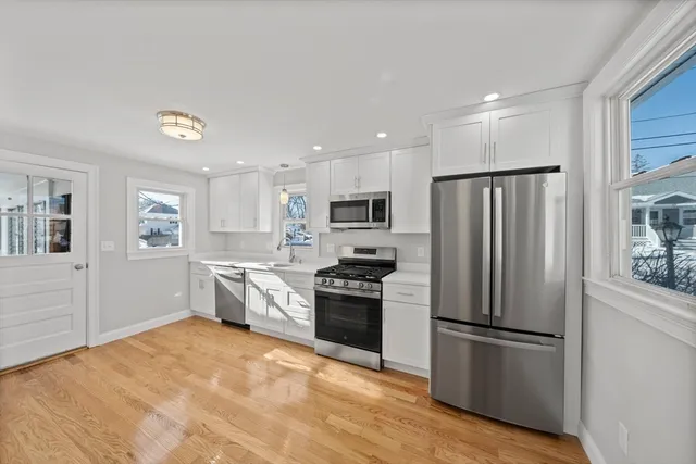 a kitchen with a refrigerator a stove top oven a sink and dishwasher