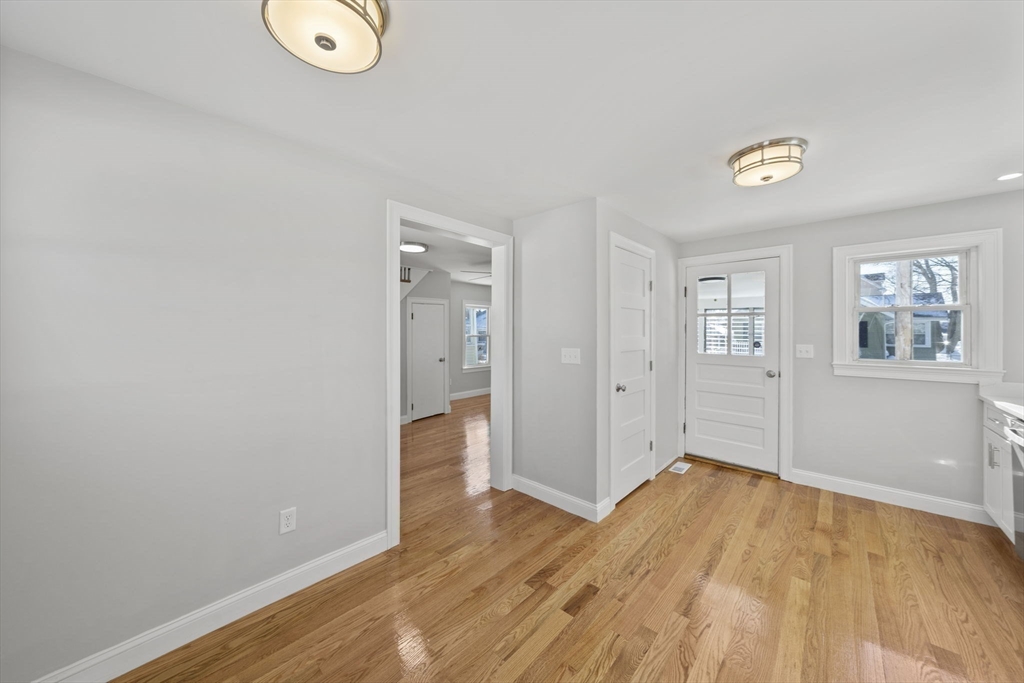 106 Darrow Street Quincy, MA 02169 - Photo 7 of 23 an empty room with wooden floor and windows