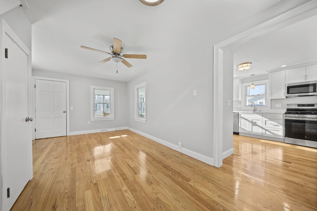 106 Darrow Street Quincy, MA 02169 - Photo 9 of 23 a view of a kitchen with wooden floor and a kitchen space