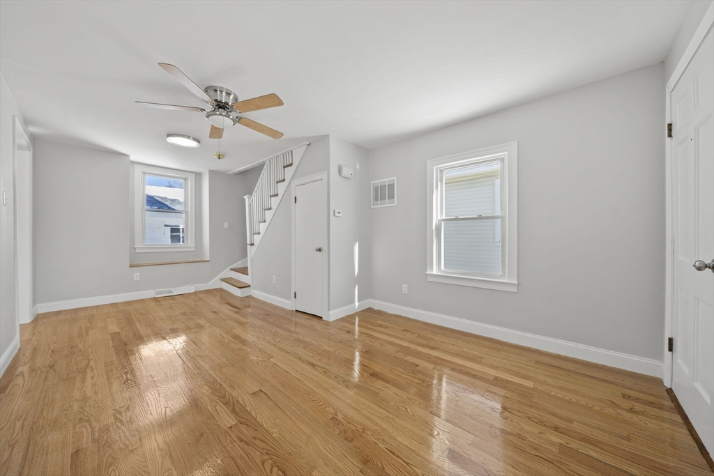 106 Darrow Street Quincy, MA 02169 - Photo 10 of 23 a view of empty room with wooden floor and fan