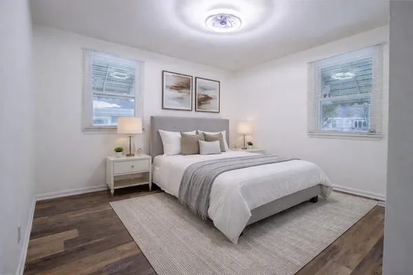 a bedroom with a bed and a night stand