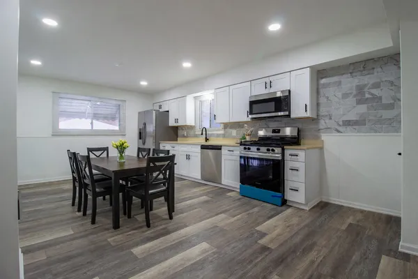 a kitchen with a table chairs sink and microwave