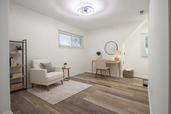 a living room with furniture and a piano