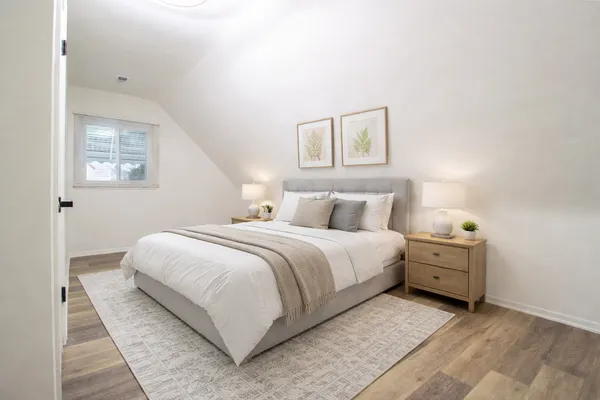 a bedroom with a bed and a night stand