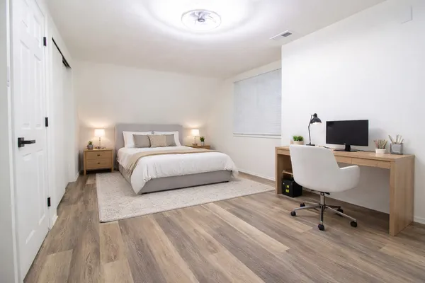 a bedroom with a bed and chair