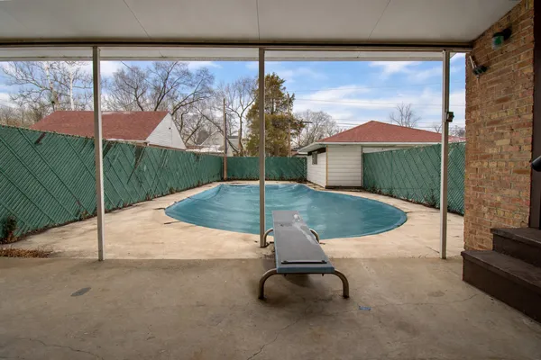 a room with pool table and chairs
