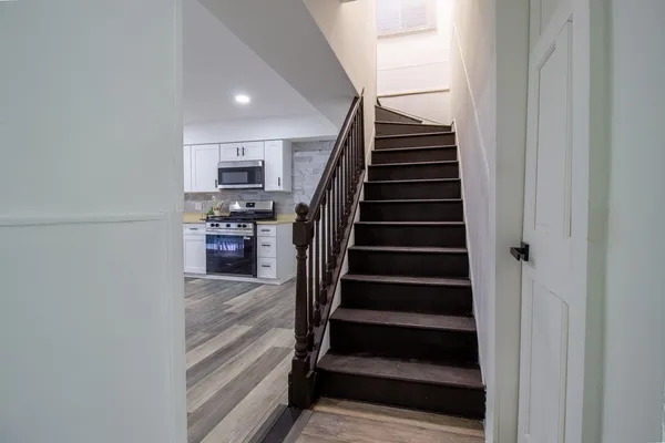 a view of entryway and hall with wooden floor