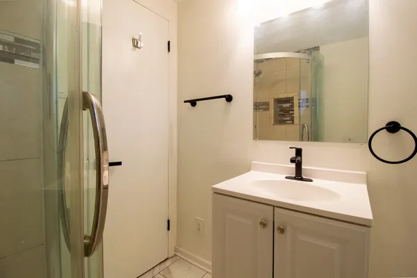 a bathroom with a sink a mirror and a shower