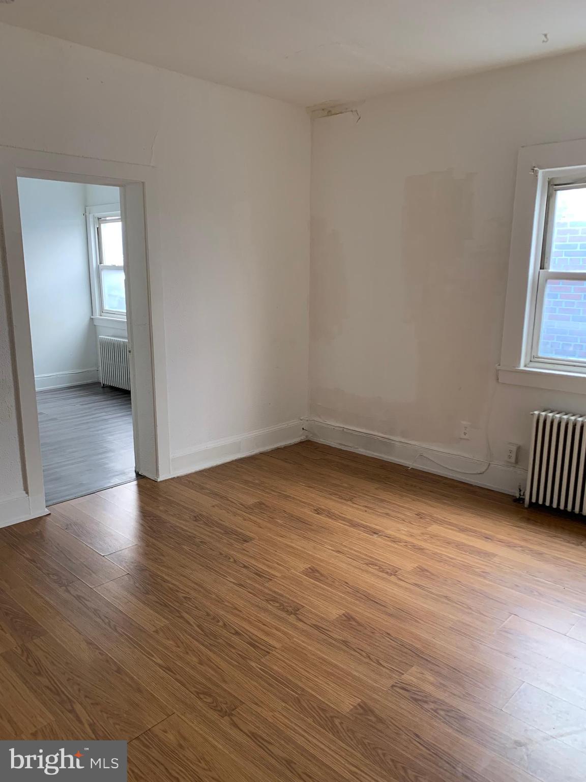 65-69 High Street, Unit 5 Mount Holly, NJ 08060 - Photo 3 of 10 an empty room with wooden floor and windows
