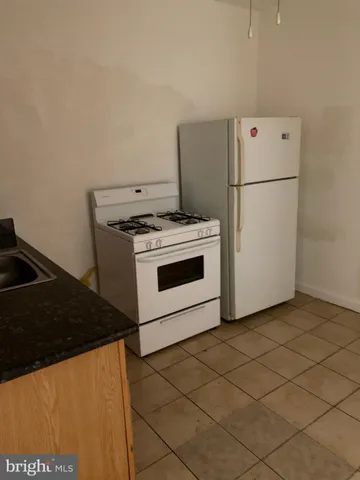 a stove top oven sitting inside of a kitchen