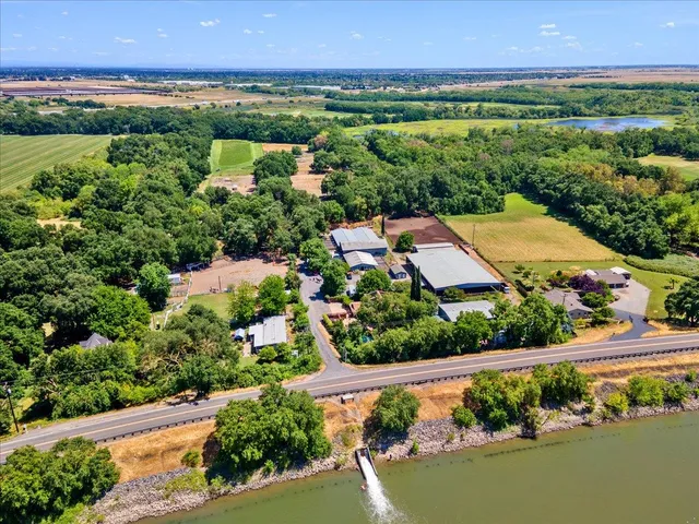 an aerial view of a city with lots of residential buildings ocean and mountain view in back