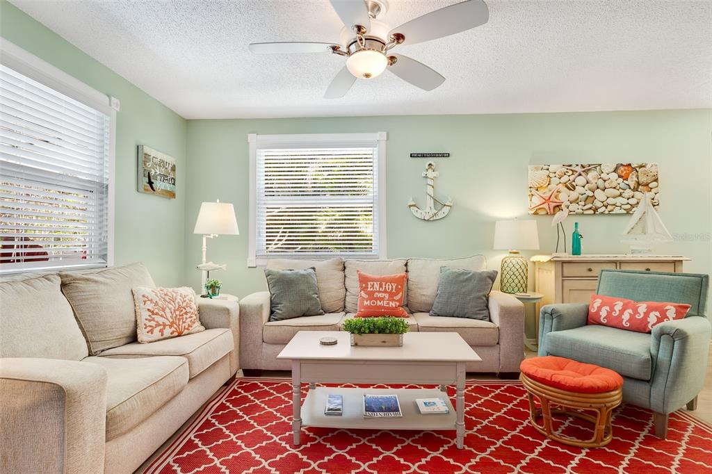 412 80th Street Holmes Beach, FL 34217 - Photo 11 of 58 a living room with furniture a rug and a window