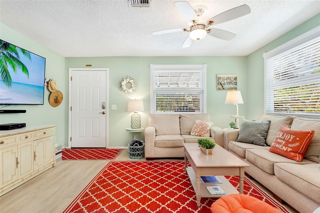 412 80th Street Holmes Beach, FL 34217 - Photo 13 of 58 a bedroom with a bed and a couch