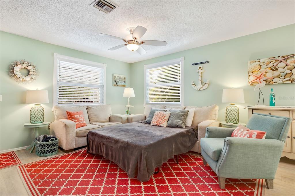 412 80th Street Holmes Beach, FL 34217 - Photo 16 of 58 a bedroom with a bed and wooden floor